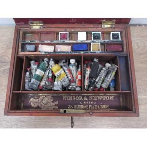 569 - A Winsor and Newton mahogany watercolour Box with paints and palette