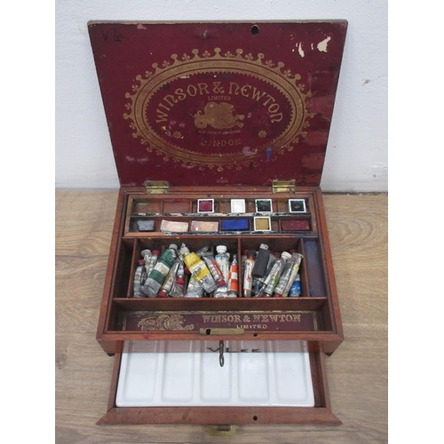 569 - A Winsor and Newton mahogany watercolour Box with paints and palette