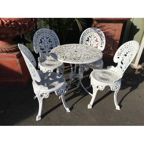 580 - A reproduction white painted Garden Table and four Chairs