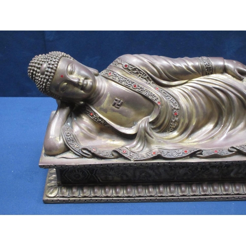 61 - A brass figure of a reclining Buddha on day bed 17 1/2in L x 8in H