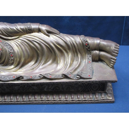 61 - A brass figure of a reclining Buddha on day bed 17 1/2in L x 8in H