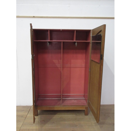 77 - An oak two door Wardrobe on stile legs 6ft 1in H x 3ft 10in W