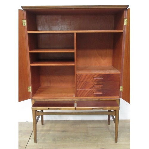 118 - A 1970's Danish style mahogany two door Cupboard fitted two brushing slides 4ft 3in H x 2ft 11in W