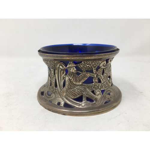 255 - An Edward VII silver Dish Holder embossed shepherd and sheep, Birmingham 1909, blue glass liner.