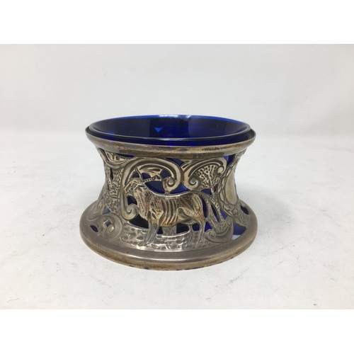 255 - An Edward VII silver Dish Holder embossed shepherd and sheep, Birmingham 1909, blue glass liner.