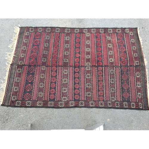 314 - A Kelim Carpet with bands of motifs on a red and blue ground, 9ft 1in x 5ft 10in