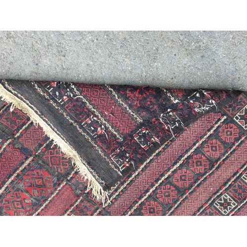 314 - A Kelim Carpet with bands of motifs on a red and blue ground, 9ft 1in x 5ft 10in