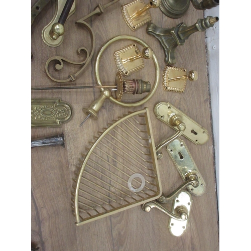 132 - A box of brass items including door handles, fittings etc