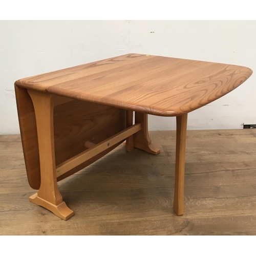 143 - An Ercol pale elm Sutherland Table with shaped supports, 3ft 4in open x 18in H