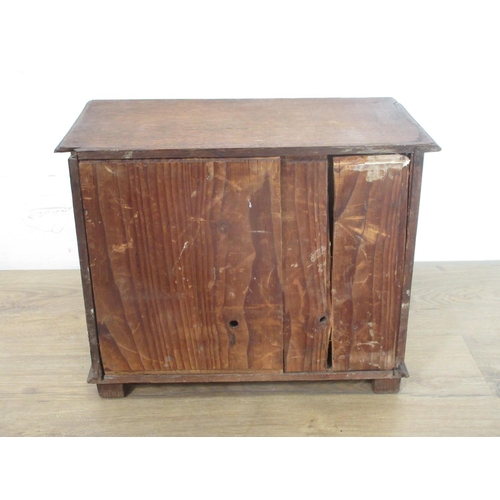 144 - An oak miniature Chest of drawers, with carved drawer fronts and ceramic knobs, 111/2in H x 14 1/2in... 