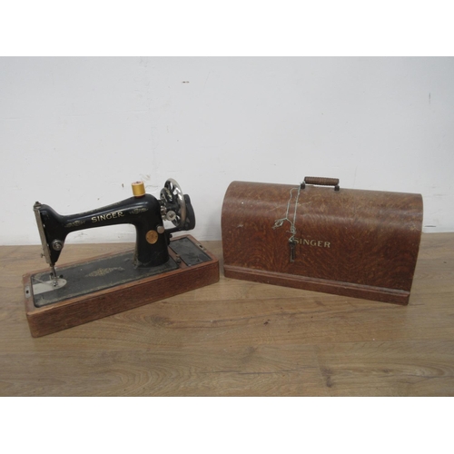 148 - A Singer Sewing Machine in oak case