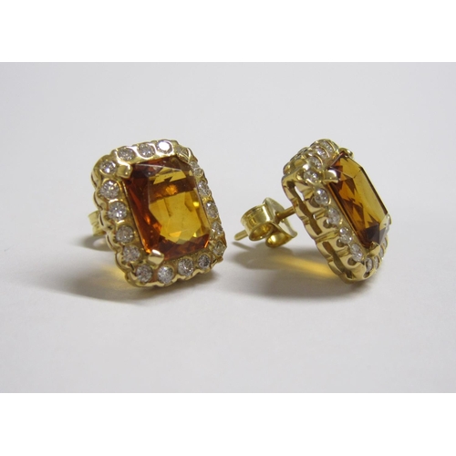 176 - A pair of Citrine and Diamond Cluster Earrings each corner claw-set scissor-cut citrine within a fra... 