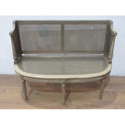 391 - A bergere and painted small Settee with cane panelled back and sides, upholstered seat on stop flute... 