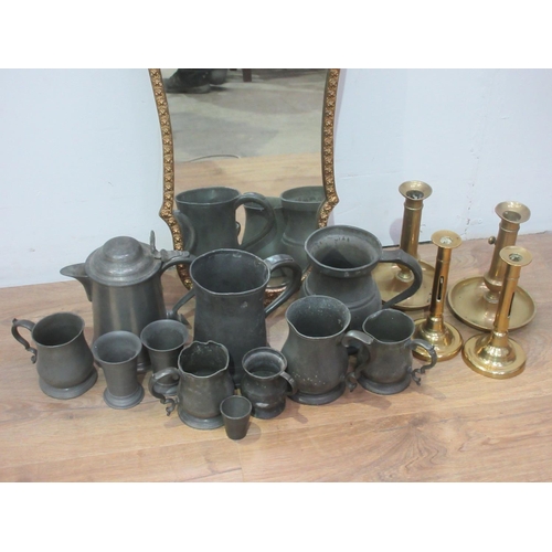 450 - A gilt framed Mirror, a quantity of pewter Tankards and four brass Candlesticks.