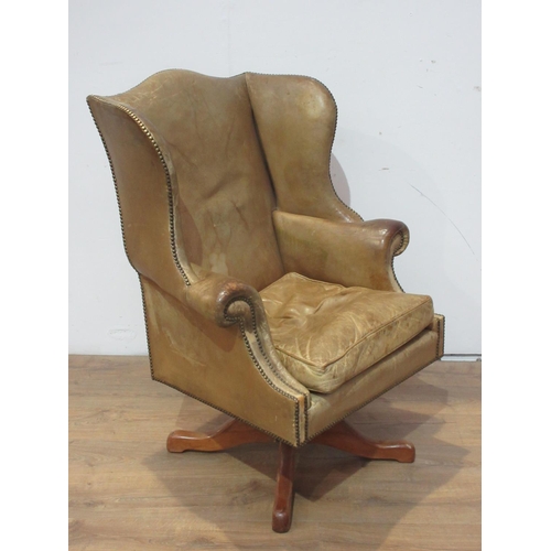 472 - A leather upholstered wingback Office Swivel Chair.