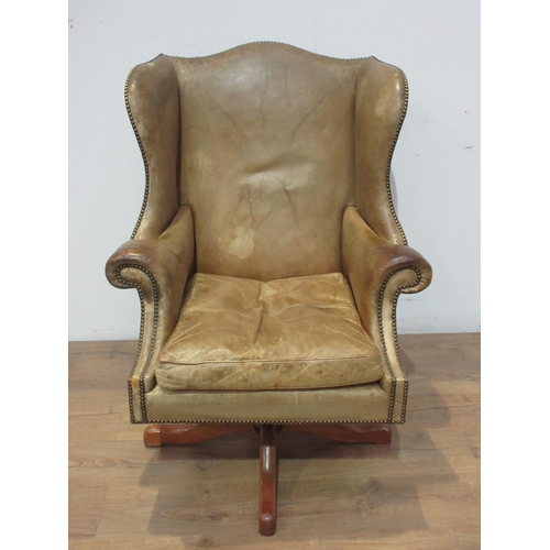 472 - A leather upholstered wingback Office Swivel Chair.