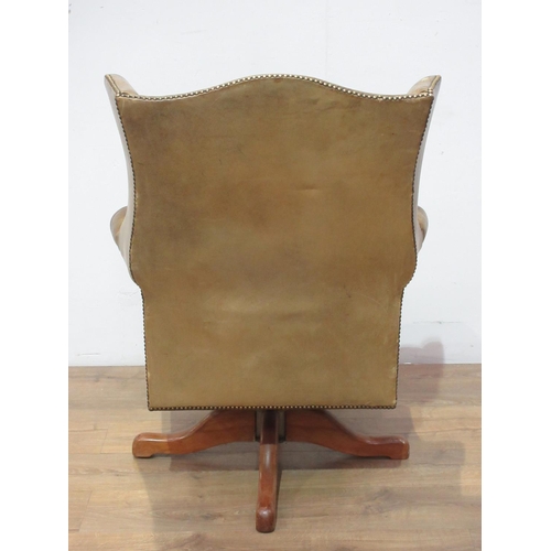 472 - A leather upholstered wingback Office Swivel Chair.