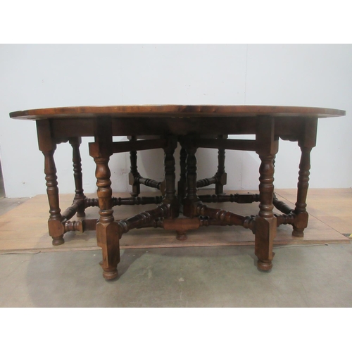 504 - A large walnut dropleaf gateleg Dining Table on turned supports and stretchers 5ft 11 in open x 6ft ... 