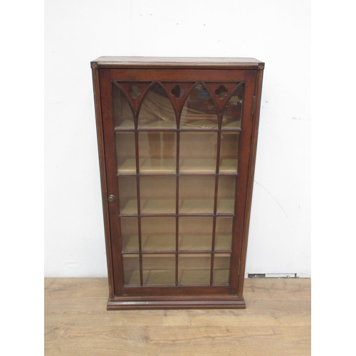 517 - An oak Cupboard the single glazed door with  Gothic features 4ft 2in H x 2ft 5in W.