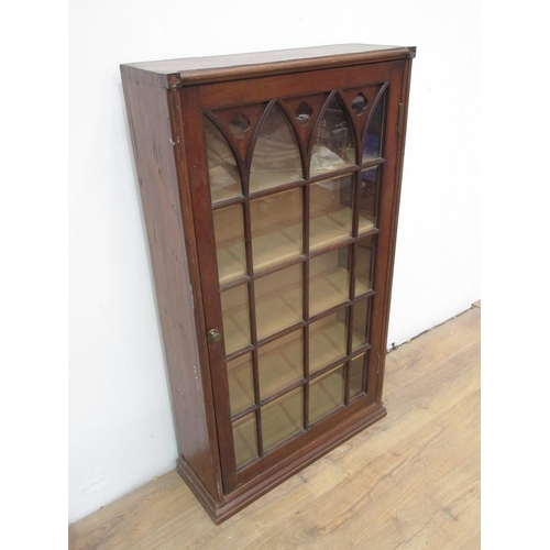 517 - An oak Cupboard the single glazed door with  Gothic features 4ft 2in H x 2ft 5in W.