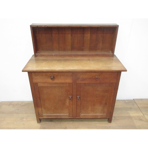 525 - A Heal & Son Ltd, London oak Cupboard with raised back mounted with turned pegs (one missing) and fi... 