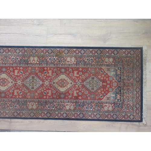 564 - A Persian style Runner with design of central lozenges on a red ground 8ft x 2ft 8in.