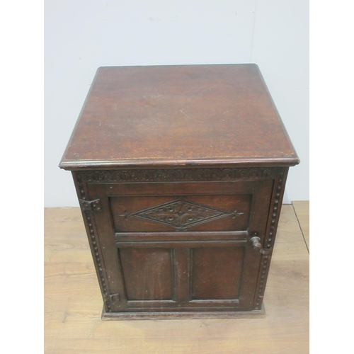 565 - A carved oak Cupboard with single panel door, lacks part of back and base 2ft 3in W x 2ft 4in Deep.