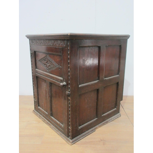 565 - A carved oak Cupboard with single panel door, lacks part of back and base 2ft 3in W x 2ft 4in Deep.