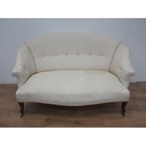 616 - A cream upholstered small Settee on shaped supports and casters 4ft 10 in W.