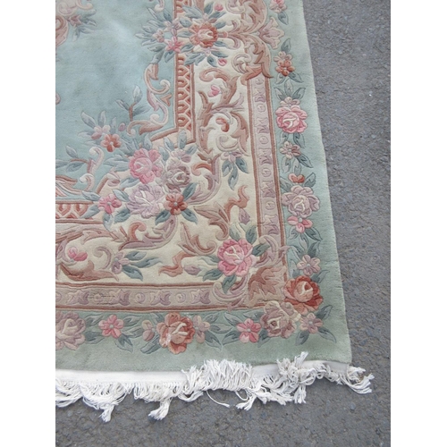 62 - A green Chinese Carpet with overall floral design 10ft 6in L x 8ft W