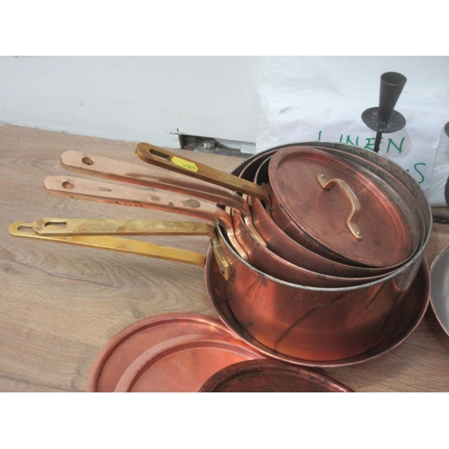 621 - A set of copper Saucepans, Lighters, wooden Bowls, Pipes and Candle Holder.