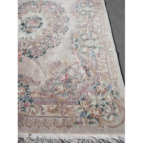 63 - A large pink ground Chinese Carpet with floral design 12ft 4in L x 8ft 10in W