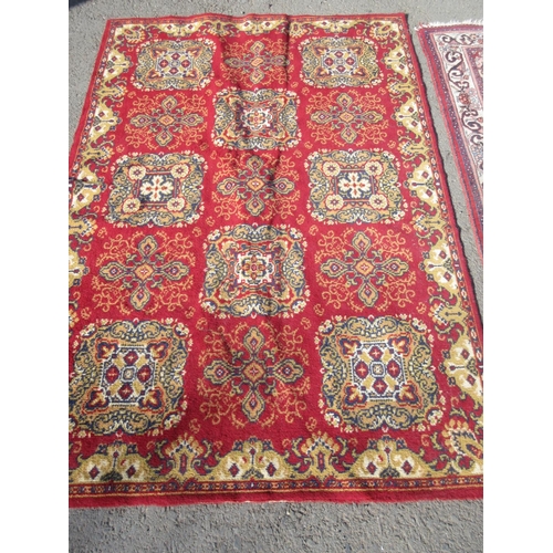 67 - A red ground woollen Rug with stylised floral design within cream border 5ft 4in L x 3ft 2in W and a... 