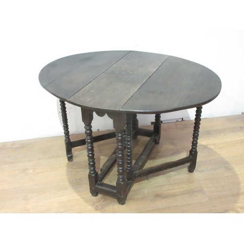 375 - A 17th Century oak Gateleg Table with oval top, raised on bobbin turned supports and squared stretch... 