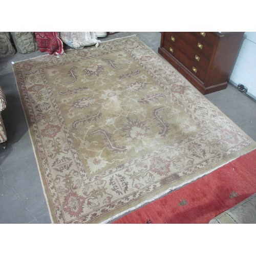 605 - A bordered Persian rug with floral motifs on a beige ground, 9ft 8in x 7ft 1in.