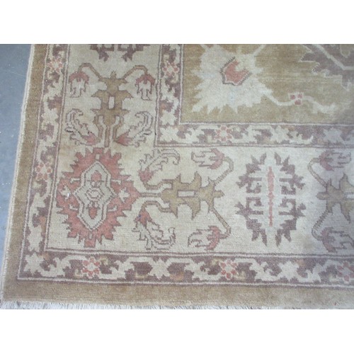 605 - A bordered Persian rug with floral motifs on a beige ground, 9ft 8in x 7ft 1in.