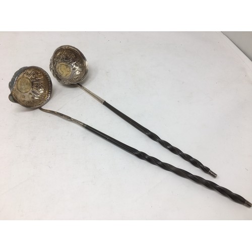 219 - Two antique silver Toddy Ladles with floral embossed bowls inset coins, dated 1709 and 1758, spiral ... 