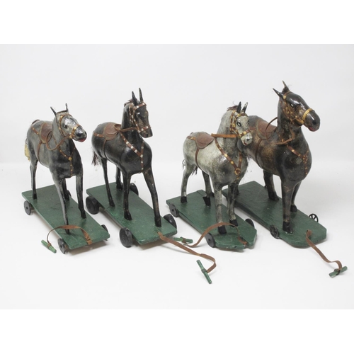 142 - An antique Folk Art blue painted pine Stable with four stalls, each containing a papier mache horse ... 