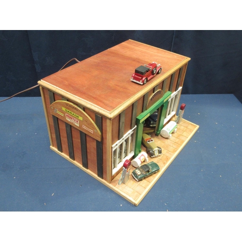 168 - A wooden scratch built model of 'Scripps Garage' with vehicles, figures and equipment 1ft 5in W x 10... 