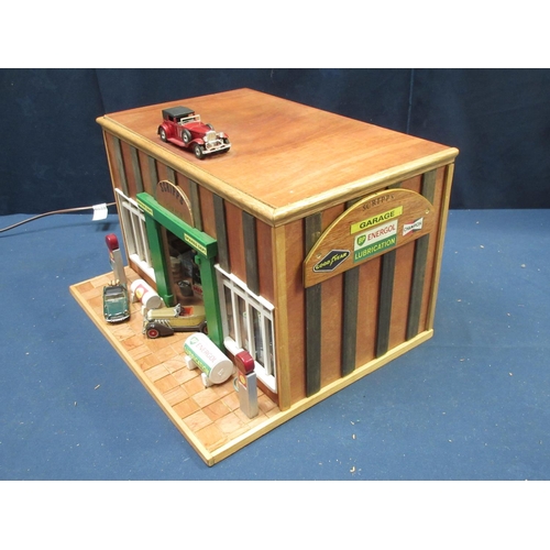 168 - A wooden scratch built model of 'Scripps Garage' with vehicles, figures and equipment 1ft 5in W x 10... 