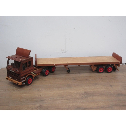 169 - A wooden scratch built model of a Scania 142E Lorry with flatbed trailer by Richard Blizzard 4ft 10i... 