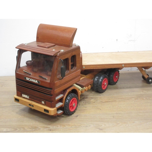 169 - A wooden scratch built model of a Scania 142E Lorry with flatbed trailer by Richard Blizzard 4ft 10i... 