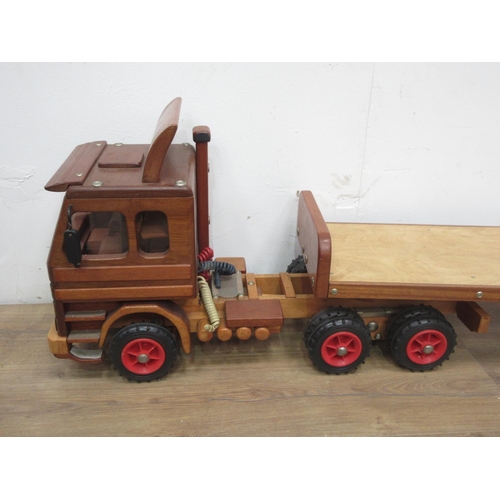 169 - A wooden scratch built model of a Scania 142E Lorry with flatbed trailer by Richard Blizzard 4ft 10i... 