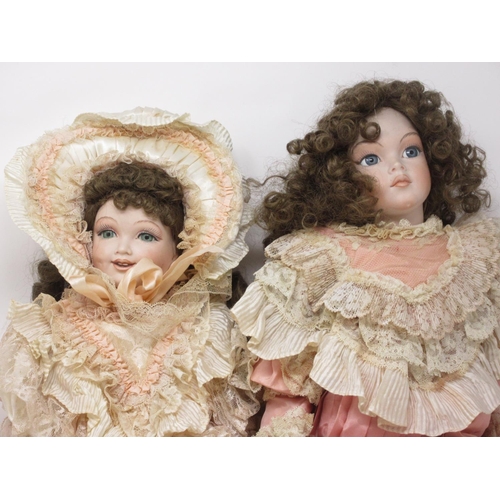 203 - Two bisque headed Girl Dolls with curly brown hair in Victorian style lace dresses, stamped Paul 198... 