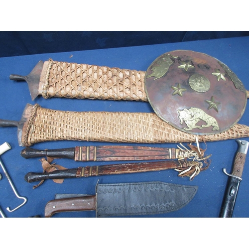 263 - Two Tribal broad bladed Spear Heads, two North African Daggers in leather scabbards, a Bayonet in me... 