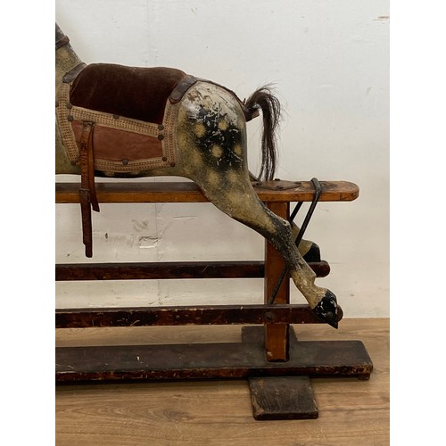 207 - A 19th Century dapple grey Rocking Horse by J.R. Smith with cushioned saddle on stained pine base 3f... 