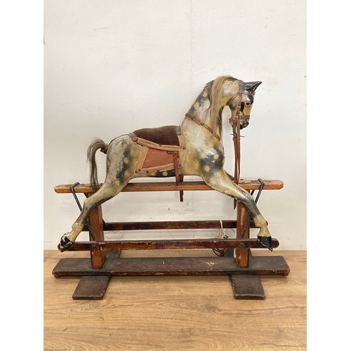 207 - A 19th Century dapple grey Rocking Horse by J.R. Smith with cushioned saddle on stained pine base 3f... 