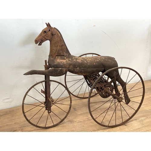 208 - A 19th Century Tricycle, the body carved as a horse with cast iron head on spoked wheels 3ft L x 2ft... 