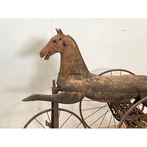 208 - A 19th Century Tricycle, the body carved as a horse with cast iron head on spoked wheels 3ft L x 2ft... 