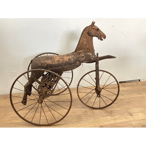 208 - A 19th Century Tricycle, the body carved as a horse with cast iron head on spoked wheels 3ft L x 2ft... 